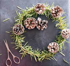acorn wreath lying on a table with scissors next to it
