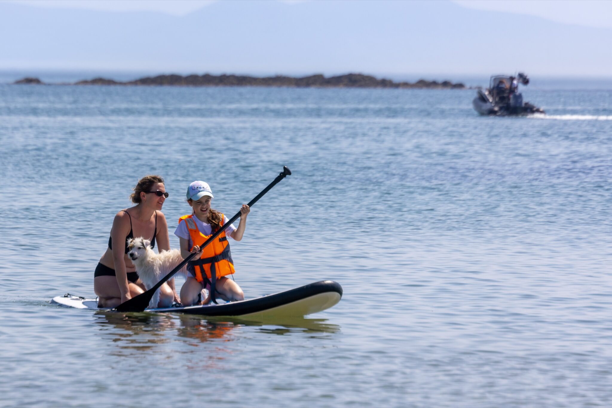 A mother and daughter paddleboarding off Silver Bay